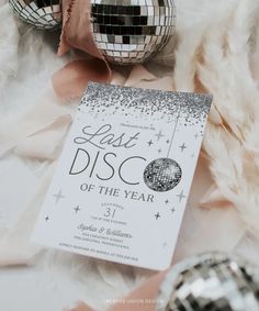 a disco ball is next to a card that says last disco of the year