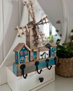 a wooden windmill on top of a shelf