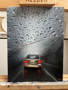 a painting of a car driving in the rain on a rainy day with words meden above it