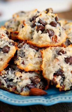 chocolate chip cookies are piled on top of each other with coconut flakes around them