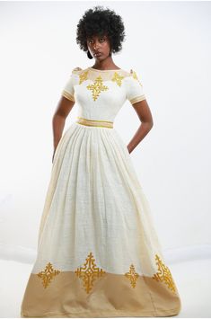 Step into the realm of opulence with our Golden Elegance Embroidered Dress, inspired by the timeless beauty of Habesha Kemis, the iconic Ethiopian cultural cloth. Crafted with meticulous attention to detail, this dress features intricate golden embroidery that exudes regal charm and sophistication. The rich cultural heritage of Ethiopia is woven into every stitch, making this dress a true masterpiece of Ethiopian craftsmanship. Indulge in the luxurious feel of the fabric as it drapes elegantly a Ethiopia Clothing, Eritrean Culture, Ethiopian Wedding Dress, Ethiopian Wedding, Habesha Dress, Ethiopian Traditional Dress, Ethiopian Dress, Habesha Kemis, Golden Embroidery