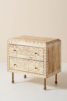 an ornate wooden chest with two drawers