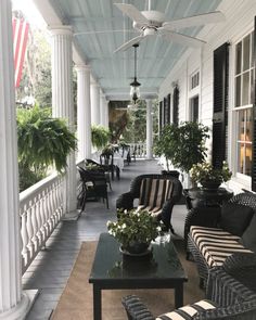 the porch is decorated with black and white furniture