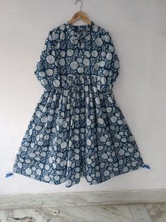 "This dress may look like a simple one but it fits and falls like a dream. Flattering to all body types, it has a shirt collar and box pleats in the skirt area. It has a big flare and the excess frill at the lower part makes it fall so well. Bonus- It comes with two pockets !! PRODUCT DETAILS - Fabric- 100% Cotton - Fir and flare - Pockets on sides - Gentle Hand Wash - Made in India Sizing- Our sizing is in inches. Please refer to the sizing below before placing your order. These are GARMENT MEASUREMENTS. Length of the Dress- 50\" 2XS- BUST- 32″, WAIST- 30″, HIPS- 36″ XS: BUST- 34″, WAIST- 32″, HIPS- 38″ S: BUST- 36″, WAIST- 34″, HIPS- 40″ M: BUST- 38″, WAIST- 36″, HIPS- 42\"\" L: BUST- 40″, WAIST- 38″, HIPS- 44″ XL: BUST- 42″, WAIST- 40″, HIPS- 46″ XXL: BUST- 44″, WAIST- 42″, HIPS- 48″ 3X Party Wear Dresses Indian, Indigo Block Print, Indian Cotton Dress, Dress Party Wear, Block Print Dress, Party Wear Dress, Circle Dress, Dress Bohemian, Dress Indian