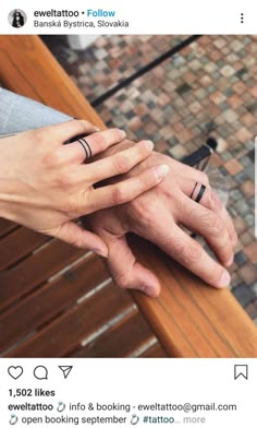 two people holding hands on top of each other with their wedding rings in front of them