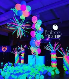 balloons in the shape of palm trees are lit up with neon colors and glows