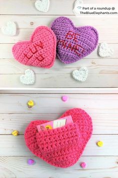 two crocheted hearts with the word love written on them, one is pink and one is purple