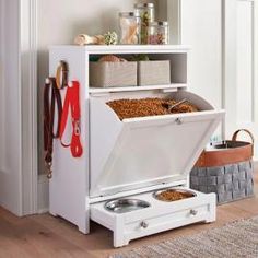 a dog food dispenser in the corner of a room with its door open