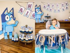 a baby sitting in a high chair next to a table with cupcakes and decorations