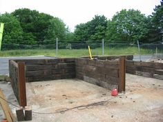 an unfinished concrete area with wooden posts