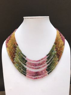 multicolored beaded necklace on a white mannequin