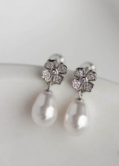 A Juliette pearl drop earrings are a charming set for the modern romantic. These short drops feel fresh and elegant with everlasting floral motifs and timeless Swarovski pearl drops. Available in silver or gold tones. Please leave your colour preference in the message box at checkout. * DETAILS * > Designed in Australia. Worldwide shipping > Silver or gold plated findings, cubic zirconias, Swarovski pearls > Dimensions: 22mm > Colour: Silver or gold * MADE TO ORDER * The Juliette ear Feminine Pearl Drop Flower Earrings For Formal Occasions, Formal Pearl White Flower Earrings With Pearl Drop, Elegant Pearl White Flower Earrings For Formal Occasions, Elegant Pearl White Flower Earrings For Formal Events, Classic White Flower Earrings For Formal Occasions, Elegant White Flower Earrings For Formal Occasions, Elegant Formal Flower Earrings With Pearl Drop, Elegant Pearl Drop Flower Earrings For Formal Occasions, Elegant Pearl Drop Flower Earrings For Formal Events