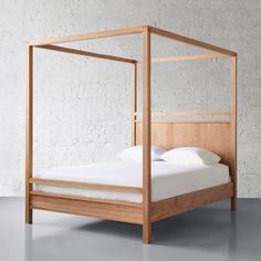 a bed with a wooden frame and white sheets