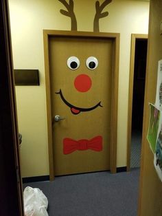 a door decorated to look like a reindeer with a bow tie and nose painted on it