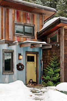 a blue house with snow on the ground