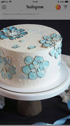 a white cake with blue flowers on it