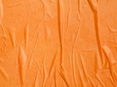 an orange sheet that is laying on the ground