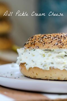 a close up of a bagel with cream cheese on it sitting on a plate