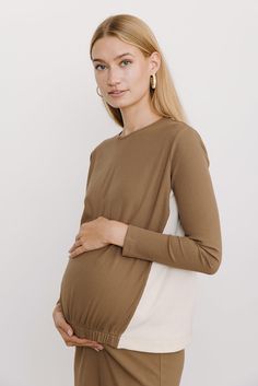 Product Details Maternity fit Fitted sleeves Ribbed lightweight material Gathered at elastic waist Model Model is 5'10" and wearing size XS. Versatile Cream Long Sleeve Tops, Versatile Long Sleeve Cream Tops, Versatile Brown Long Sleeve Top, Versatile Long Sleeve Neutral Top, Maternity Long Sleeve Cotton Tops, Neutral Long Sleeve Stretch Top, Long Sleeve Stretchy Neutral Tops, Stretch Long Sleeve Tops In Neutral Color, Spring Maternity Long Sleeve Tops