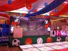 an indoor sports themed birthday party with basketballs and balls on the dancefloor