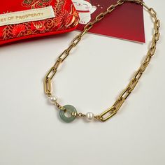 Combining the richness of pearls, the energy of jade, and the luxury of 14k gold plating over handcrafted stainless steel—our Beauty & Affluence Necklace is the perfect embodiment of sophistication. With white freshwater pearls on either side of an authentic 12mm round Burmese jade, this necklace isn't about aesthetics. It holds significant symbolism. Pearls are linked to purity, wisdom and abundance, while jade represents resilience and safeguarding. Details 14k gold plated on handcrafted stain Elegant Jade Necklace With Adjustable Chain, Gold-plated Pearl Necklace With Gold Chain For Gift, Elegant Jade Pearl Necklace For Gift, Burmese Jade, Jade Crystal, White Freshwater Pearl, Demi Fine Jewelry, White Gold Jewelry, Jade Stone