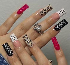 the woman is holding her hands with different nail designs on their nails, including leopard and cheetah