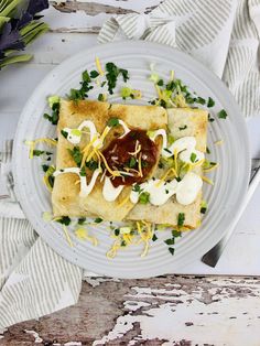 a white plate topped with food on top of a wooden table