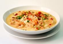 a white bowl filled with soup on top of a table