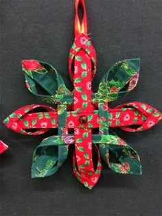 an ornament made out of paper and ribbon