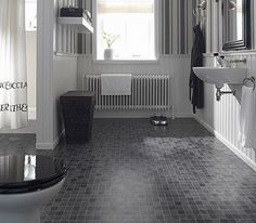 a bathroom with black and white tile flooring