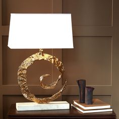 a table with a lamp and some books on it