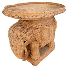 an elephant shaped wicker table with its trunk resting on it's back