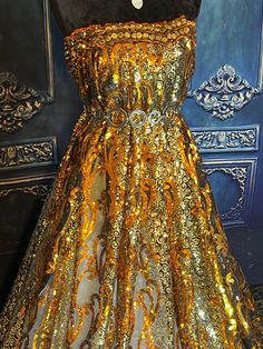 "Very Beautiful and shiny sequined lace. Premium quality. Orange gold and silver. Width 53\". Price for 1 yard." Gold Glitter Dress For Wedding, Gold Shimmer Dress For Wedding, Holiday Gold Sequin Embellished Dress, Holiday Gold Embellished Sequin Dress, Gold Sequin Dress With Contrast Detail For Wedding, Glamorous Gold Sequin Dress With Contrast Sequins, Glamorous Gold Sequin Dress With Contrast, Glamorous Gold Sequin Dress With Contrast Details, Festive Gold Dress With Sequins