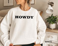 "Howdy Sweatshirt, Cowboy Sweatshirt, Country Sweatshirt, Valentines Day Sweatshirt, Valentines Day Gift,  Sweatshirt Gift for Women HOW TO ORDER: 1. Please, Check and Review all Photos and Size Charts (The V-necks and Tank Tops are Women's Size, and the other styles are Unisex) 2. Choose Your T-Shirt Color/Size (You can see youth and toddler options in the same drop-down menu) 3. Choose Your Quantity as much as you want. 4. Click \"Add To Cart\". For multiple items go back to the listing and re Wifey Sweatshirt, Mrs Sweatshirt, Bride Sweatshirt, Country Sweatshirts, Gift For Bride, Oversized Crewneck, Bridal Shower Gift, Mom Tees, Baseball Mom