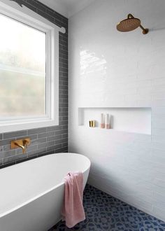 a white bath tub sitting next to a window