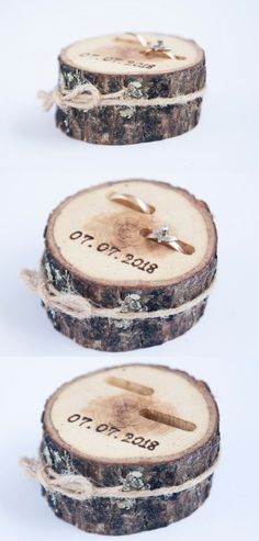 two pieces of wood with wedding rings on them sitting next to each other in front of a white background