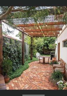 an outdoor patio with brick walkway and pergolated roof