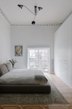 a large bed sitting in the middle of a bedroom