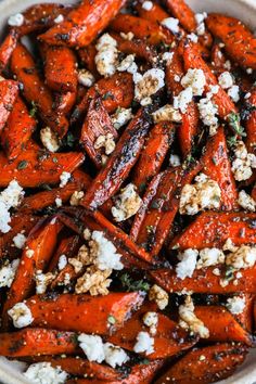 a bowl filled with carrots and feta cheese