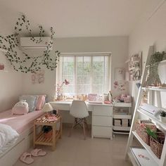 a bedroom with white walls and lots of pink accessories on the bed, along with other furniture