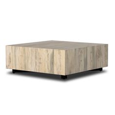 a square wooden table sitting on top of a white floor