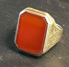 "Classic 14k yellow gold ring, rectangular bezel set Carnelian (16 by 13mm), with terrific hand engraved setting, strong good looking design.  Size 7 3/4, wt.-  4.3 grams.  Top of ring approx. 3/4\" north to south on finger.  Classic shape and easy to wear.  Circa 1920-30.  good condition, clean design, any wear commensurate with age and slight, Photos show details." Rectangular 14k Stamped Signet Ring Collectible, Gold Rectangular Cabochon Rings, Rectangular Gold Cabochon Rings, Rectangular Cabochon Gold Rings, Rectangular Gemstone Signet Ring In Fine Jewelry Style, Formal Rectangular Cabochon Ring, Rectangular Cabochon Yellow Gold Ring, Rectangular Yellow Gold Signet Ring With Gemstone, 14k Stamped Rectangular Signet Ring Collectible