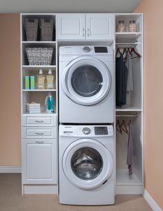 a washer and dryer in a small room with shelves on the wall behind them