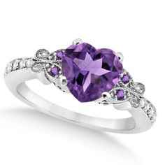 Long reserved solely for royalty, the amethyst is a majestic gemstone your queen is sure to love, especially in this butterfly designed amethyst and diamond heart engagement ring. Featuring an approximate carat weight of 2.48 total carats, this stunning ring features a total of 5 genuine amethysts and 10 diamonds. Set in 14k white gold this dazzling engagement ring is sure to please. #engagementring #engagementringideas #engagementringselfie  #engagementringonline#engagementringdesigner Purple Engagement Rings, Butterfly Engagement Ring, Shell Jewellery, Heart Engagement, Diamond Sapphire Engagement Ring, Sapphire Diamond Engagement, Amethyst Ring Engagement, Jewelry Tips, Rings Accessories