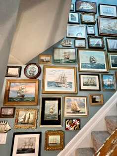 a staircase with many framed pictures on the wall