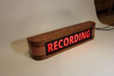 a wooden sign that says recording on it