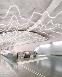 an empty airport with white lines on the ceiling