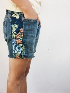 a person wearing shorts with flowers on them