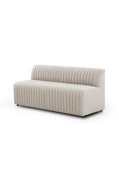 a white couch sitting on top of a white floor