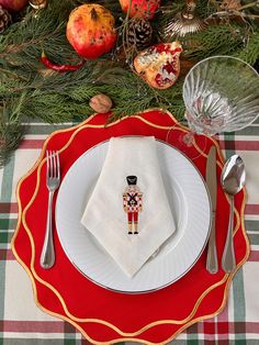 a christmas place setting with silverware and napkins